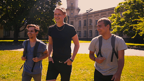 3 guys walking on college campus